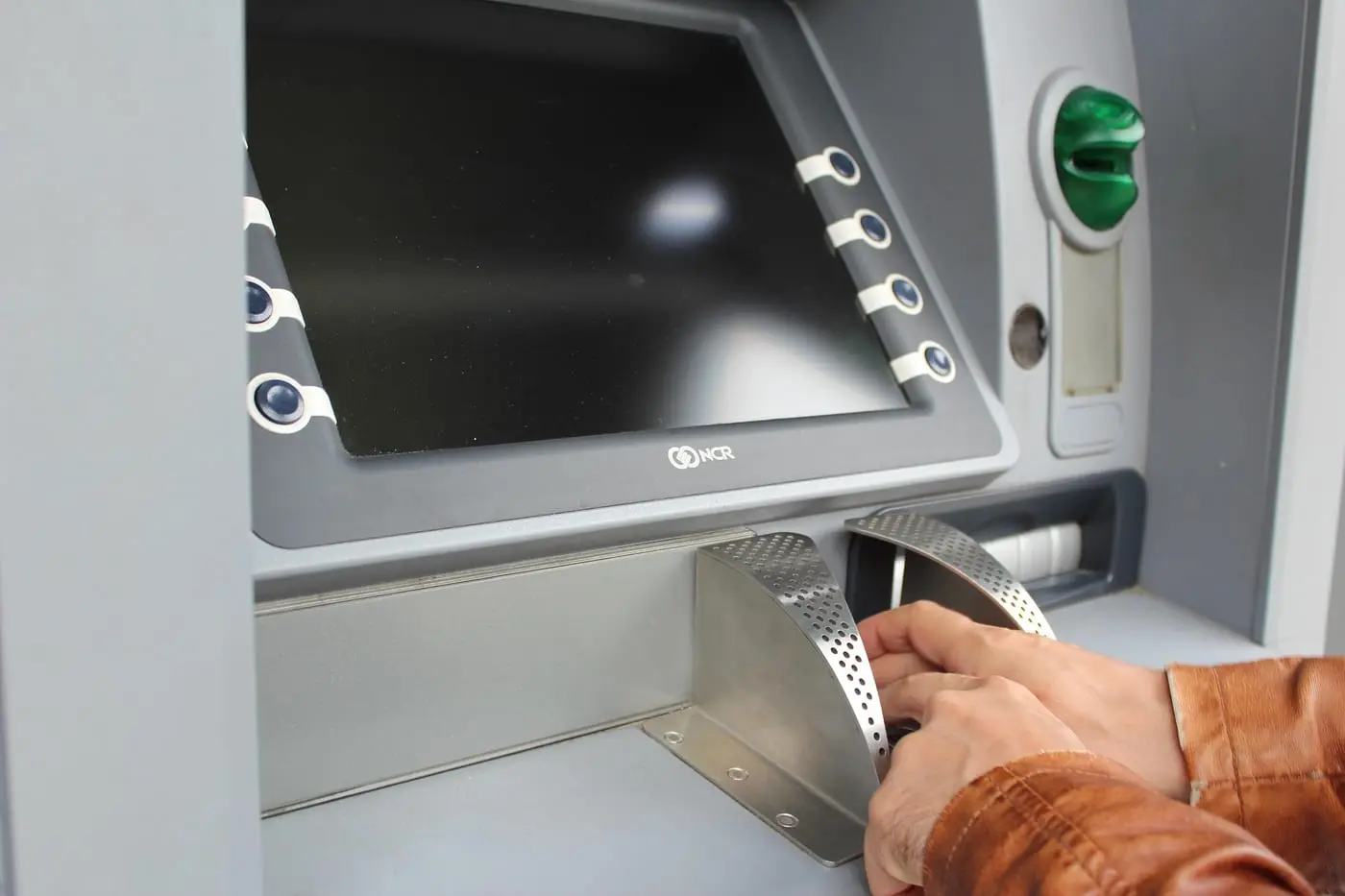 Person using a cryptocurrency ATM terminal
